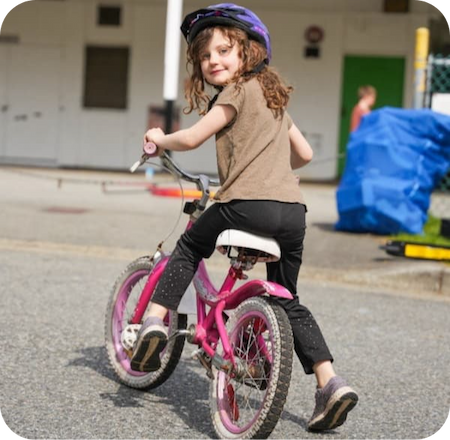 Child on bike in school 450